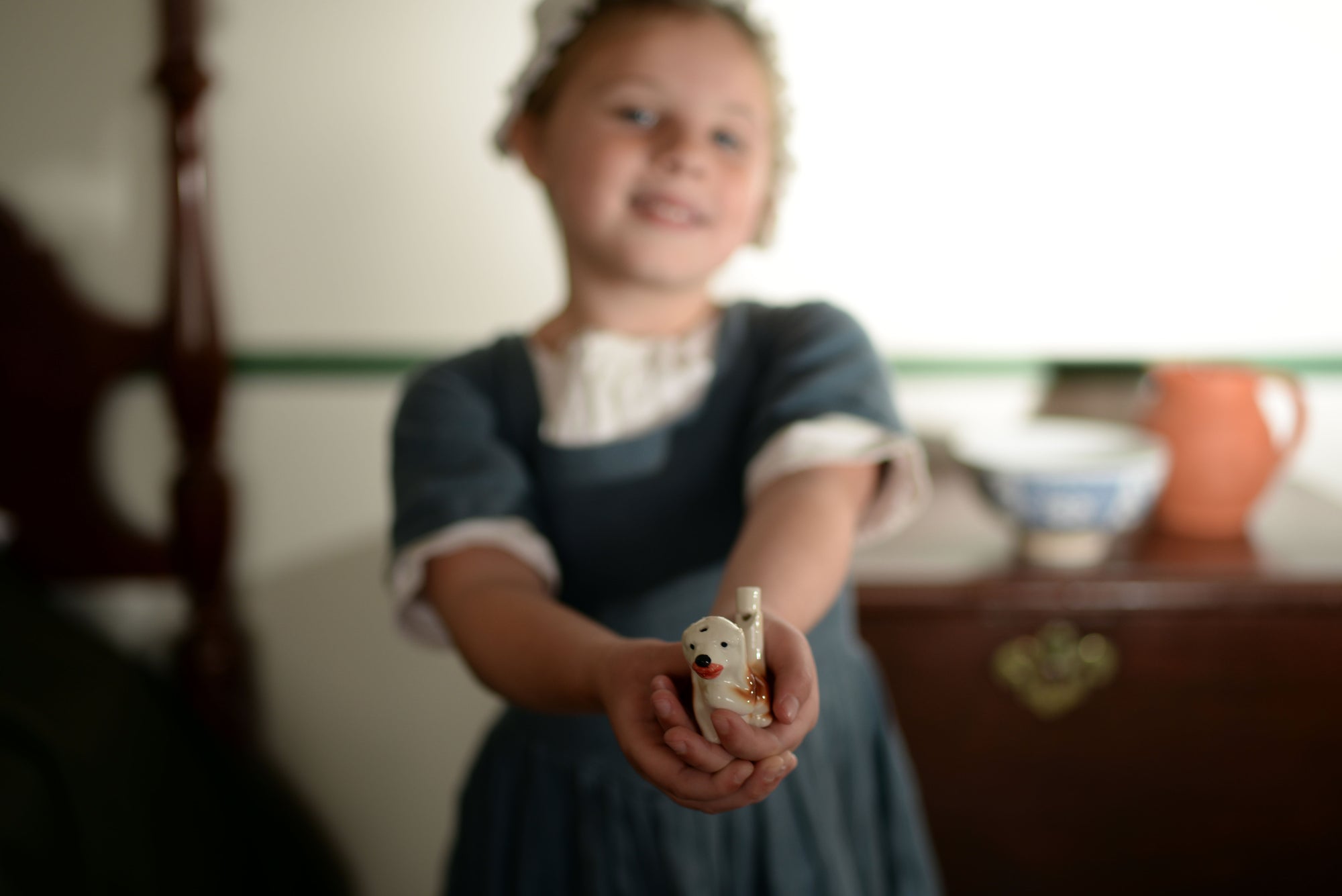 Child holding bird whistle