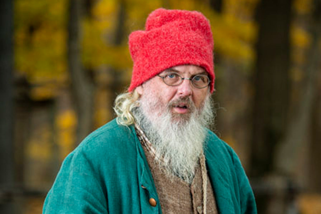 Man wearing 18th Century Red Toque Hat